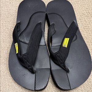 The Healing Some Black Flip Flops